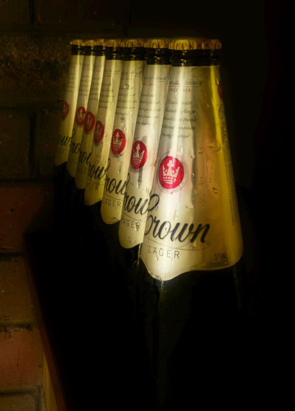 Seven bottles of beer near a wall