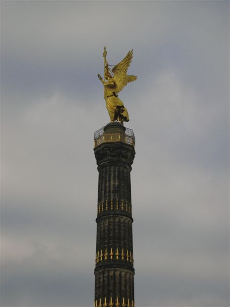 the larger gilded lady on top stands 8.3m tall, predictably represents the goddess of Victory