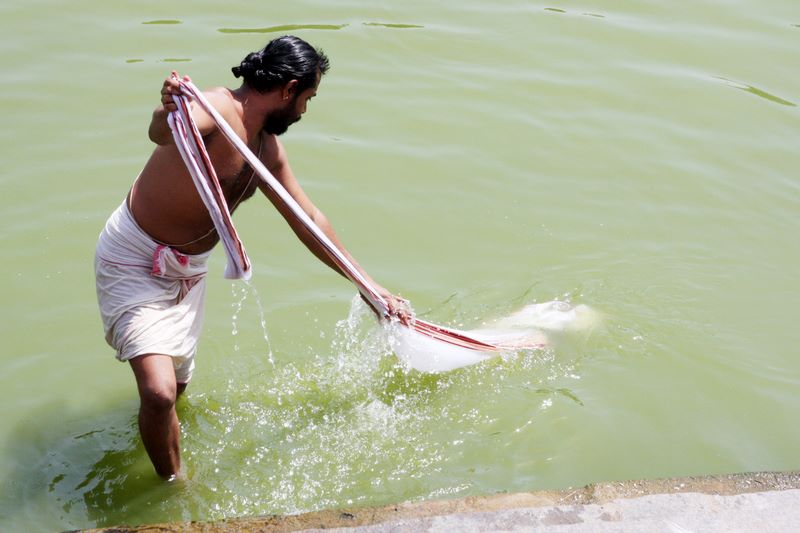 A priest washes his clothes, Varadaraja Perumal Temple, Kanchipuram, India