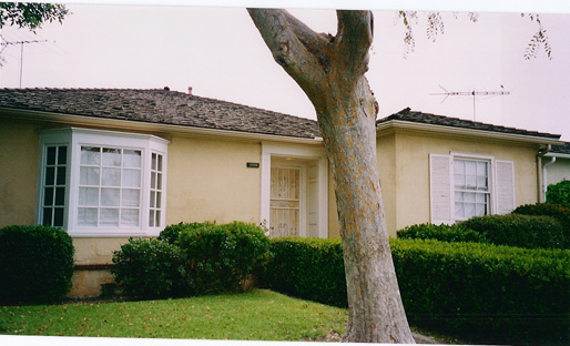This is another view of the front yard when we moved in. Although, the bars are no longer on the windows in this picture.
