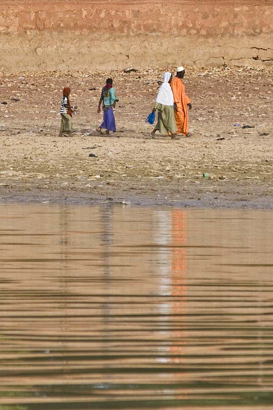 A Family Strolling on the Bani River Bank