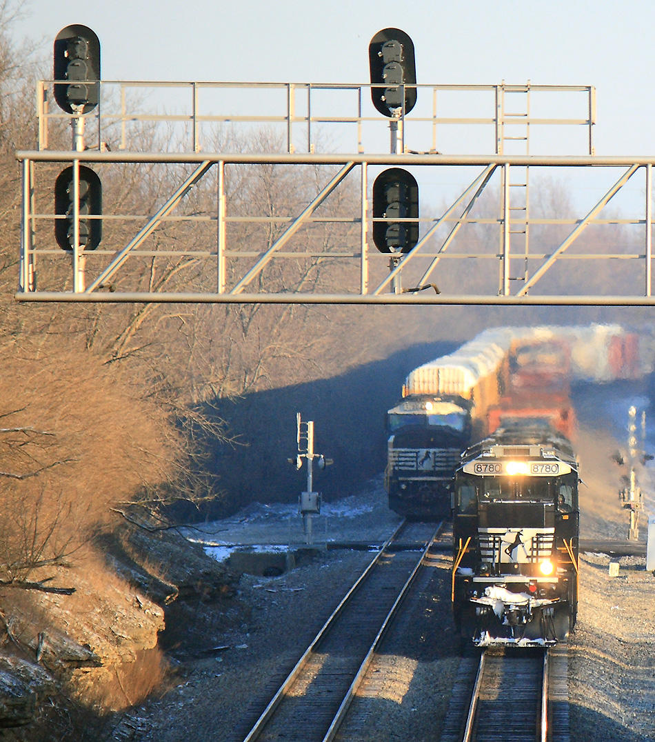 The sun is just breaking over the ridge as NS 143 passes 289, which was changing crews for the trip West. 