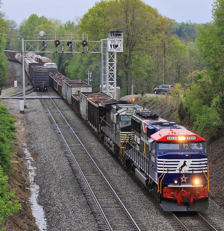 The new signal bridge at Southern States is up and ready to be cut in, as 179 passes under the old Searchlights 