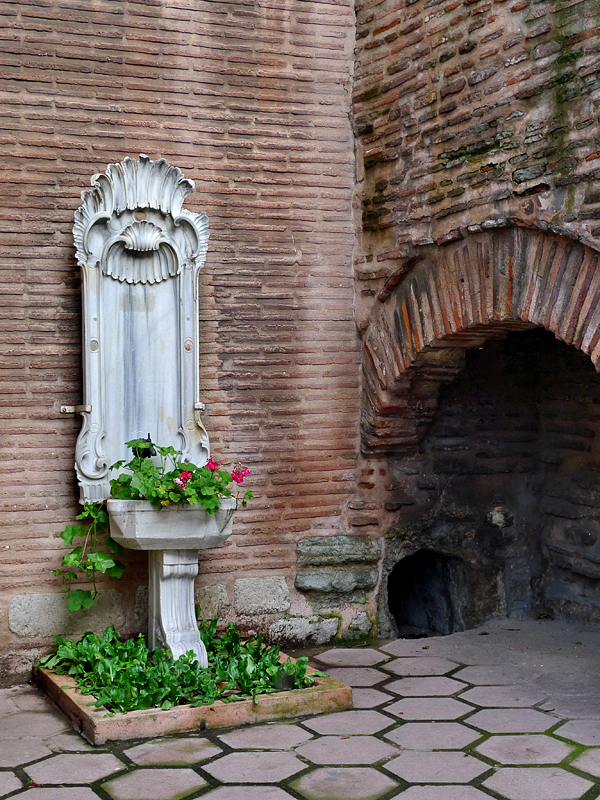 Old fountain, ancient backdrop