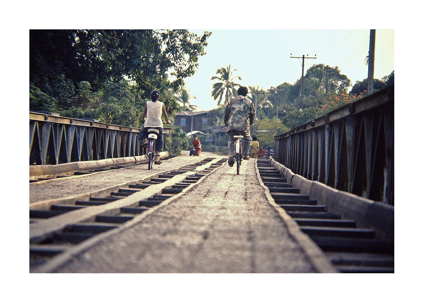 Bicycles crossing bridge, Laos