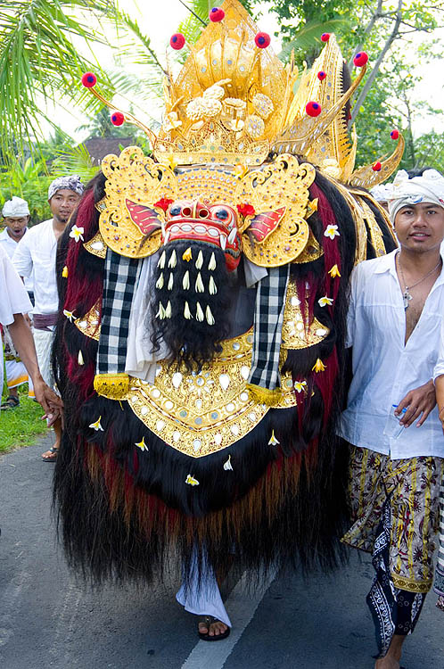 Barong figure leads a temple procession, Benyutung