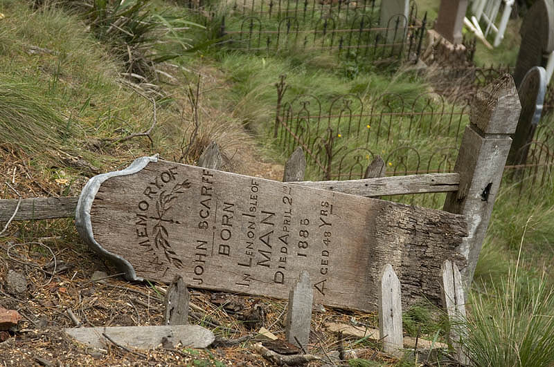 Broken grave marker in the hillside cemetery
