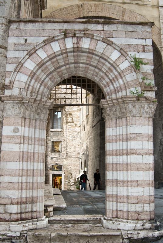 Ancient stone arch leading down off the Corso Vanucci