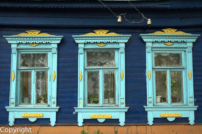 Fretwork windows of a log home, or Izba