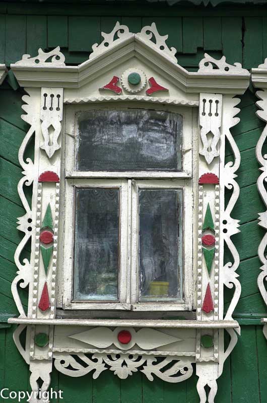 Fretwork windows of a timber cottage, or Izba