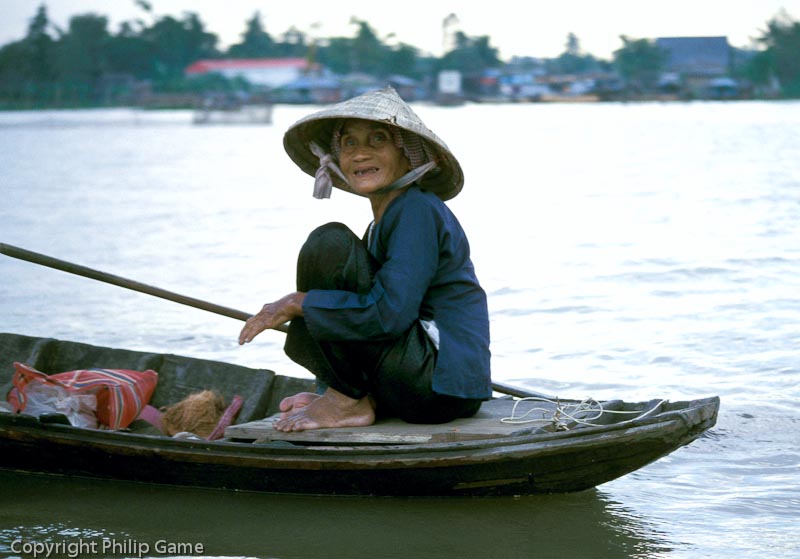 Boatwoman on a branch of the Mekong