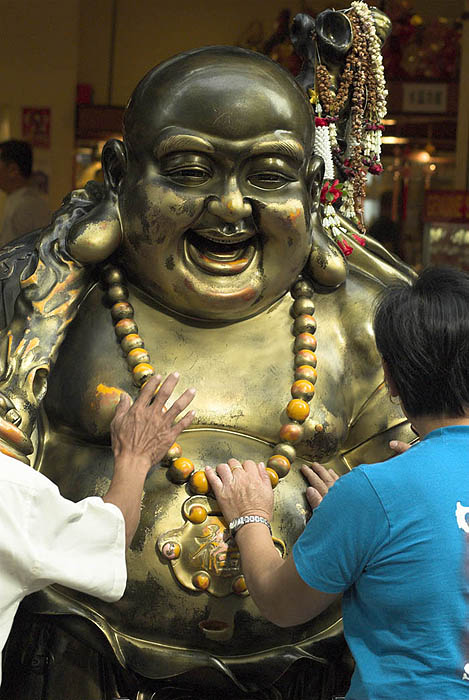 Rubbing Buddha's belly in Waterloo Street