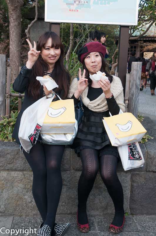 Visitors to Kamakura, tucking into local treats