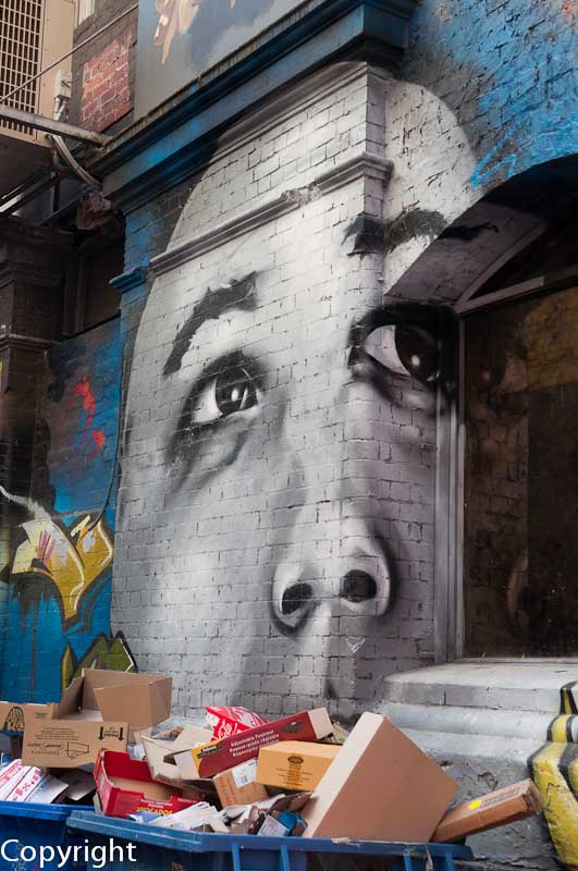 Street art co-exists with dumped rubbish