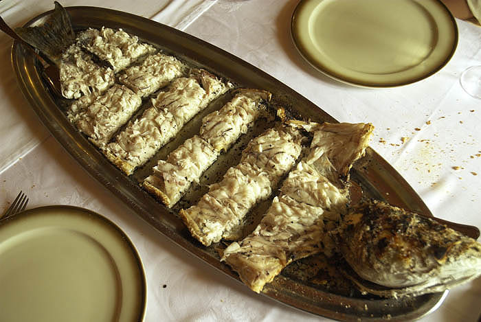 Baked sea bass served at table (Galicia)