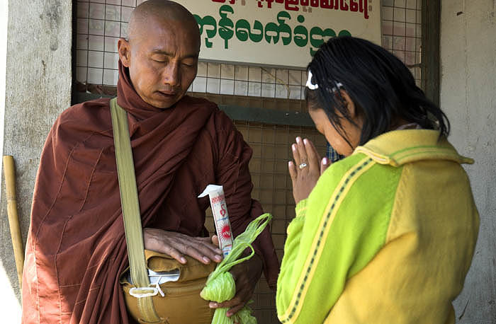 A monk blesses the giver of alms, Tachileik
