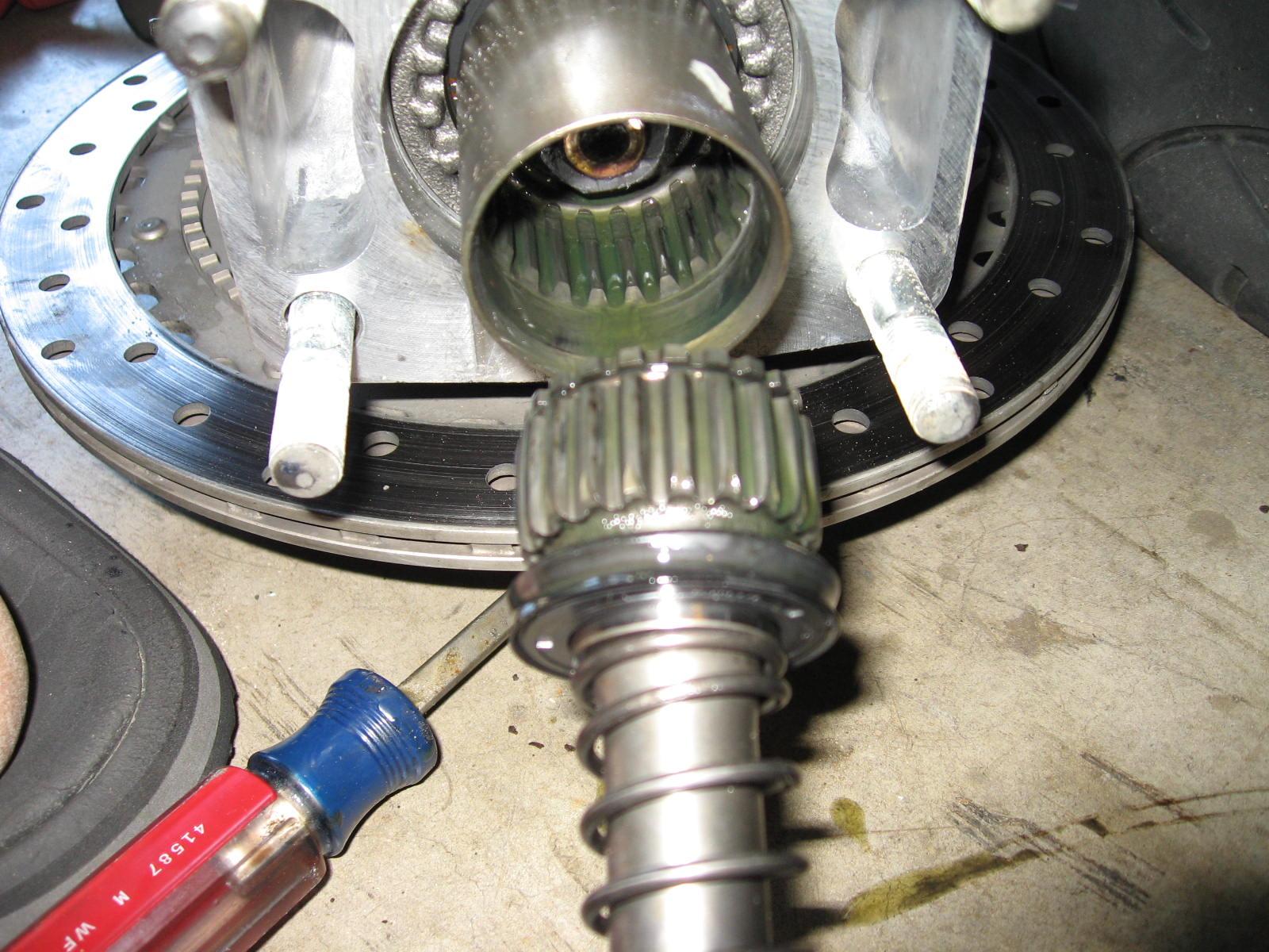 Input shaft simply pulls out, with seal. You really should replace the seal if you do this. Dont remove unless you need to.