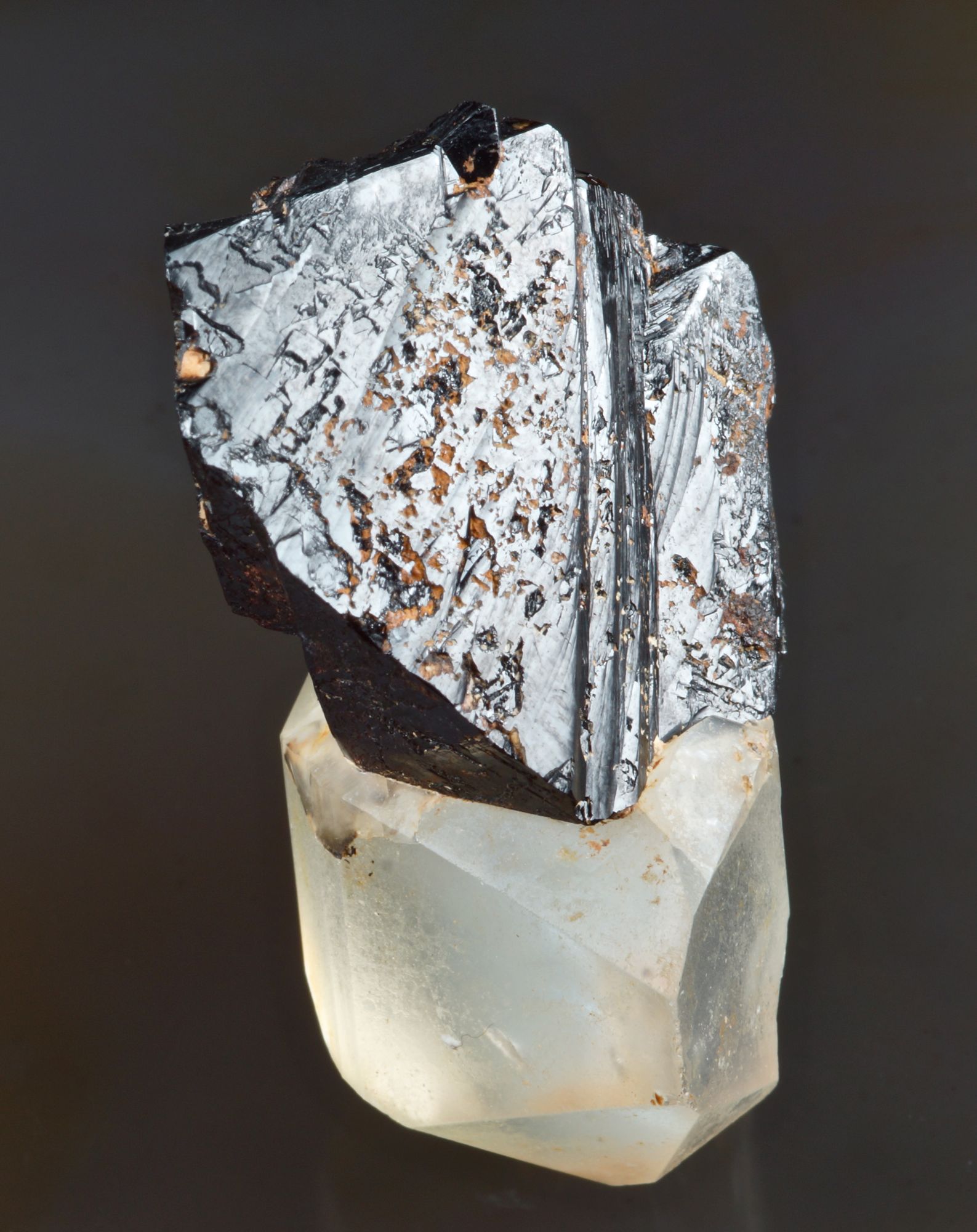 Cassiterite, glossy sharp 32 mm crystal group on a doubly terminated 3 cm quartz crystal. Sakangyi area, west of Mogok, Burma.