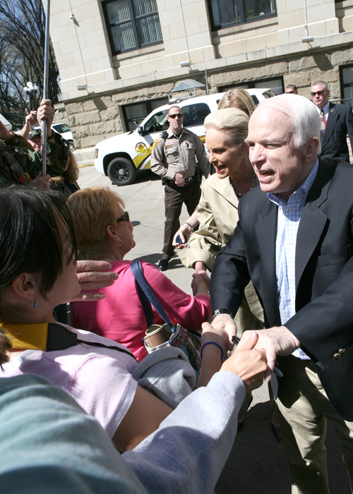 Mia and Cory shaking hands at the same time with John McCain