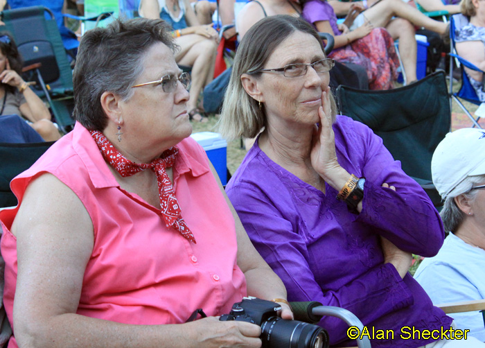 Laura and Terre intently watching Ani Difranco, Meadow Stage
