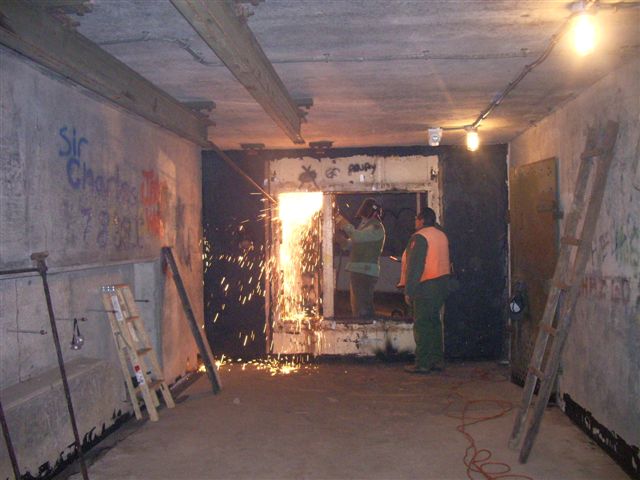 January 29, 2008. NPS crew cutting out non-historic steel doors at north end of main corridor.