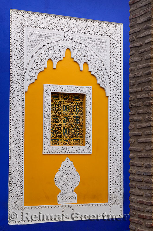 Ornate yellow window at the cobalt blue Islamic Art Museum of Marrakech at Majorelle Garden Morocco