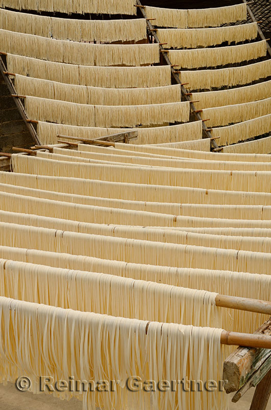 Racks of raw noodles hanging outside to dry in Fuli near Yangshuo China