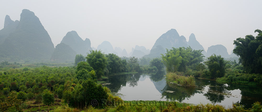 Receeding peaks of karst limestone in the haze on the Yulong river Yangshuo China