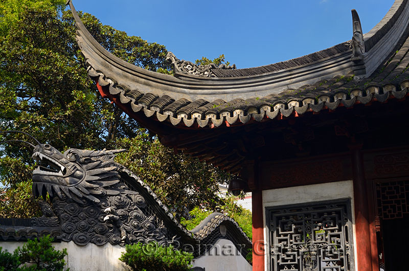 Dragon head of five dragon wall with Ancient Well pavilion at Yuyuang Gardens Shanghai China