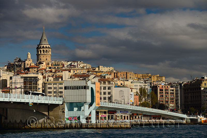 Galata Tower and Bridge in sun with clouds from Eminonu terminal Istanbul on the Goden Horn