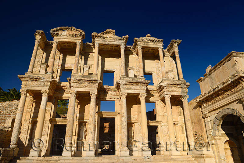 Ruins of the facade of the Library of Celsus and Mazaeus gate to the Agora of the ancient city of Ephesus Turkey