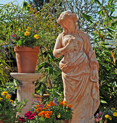 Ceramic maiden enjoying gardens