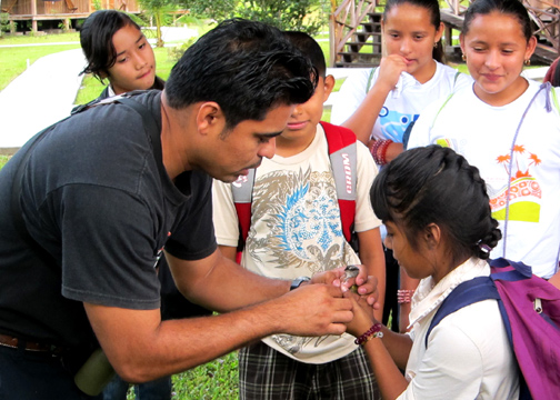 Vladimir showing student how to hold and then release a banded bird.  Kids were giddy over prospect of releasing a bird!