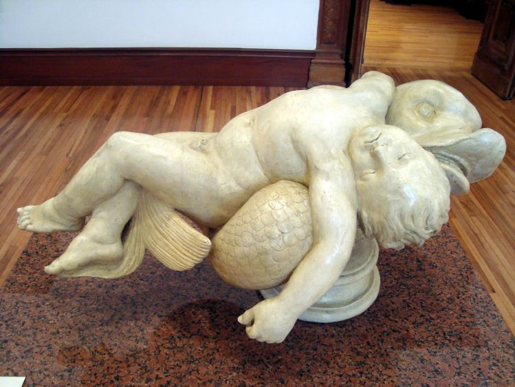 El amor recostado sobre un delfn