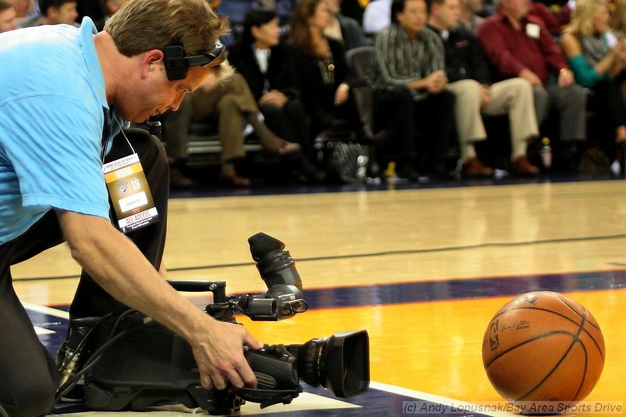 TV cameraman shooting the basketball