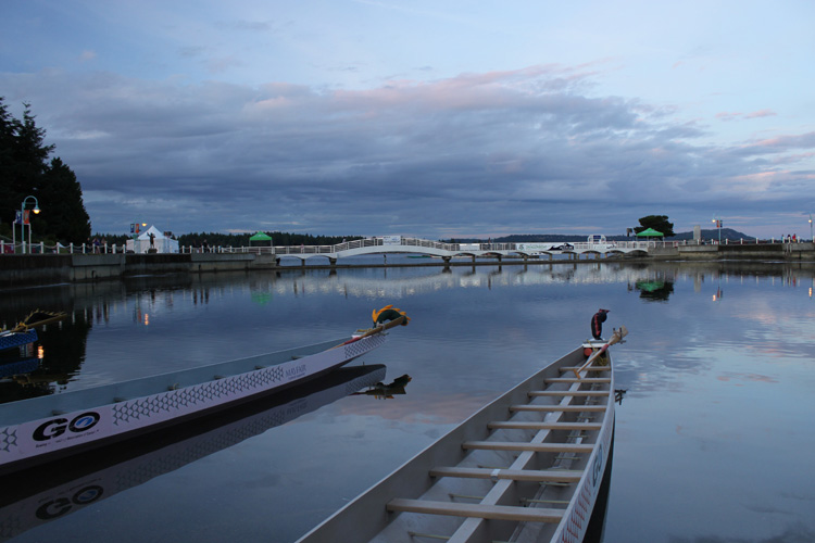 sun sets as boats wait.