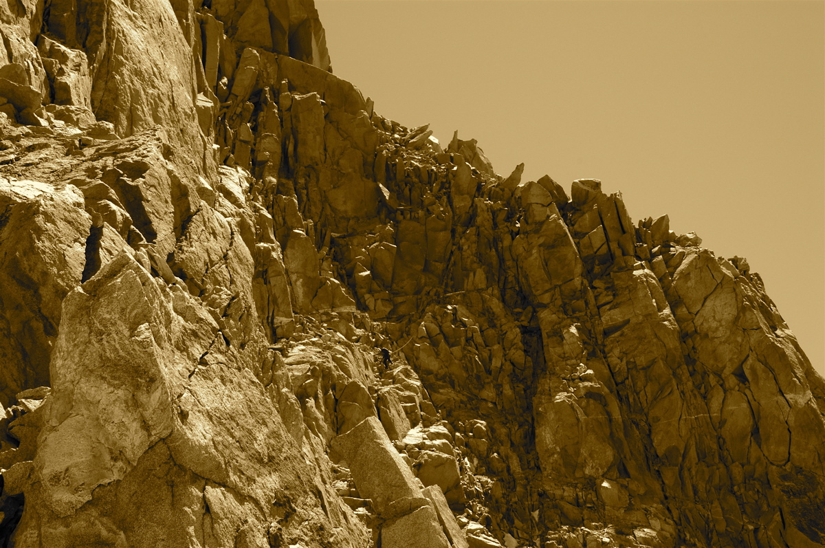 Two small climbers, one large mountain