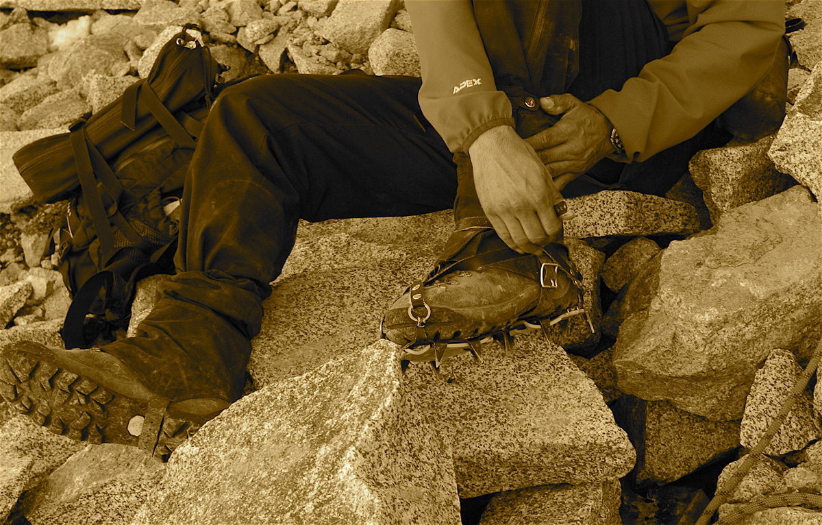 Putting on traditional crampons