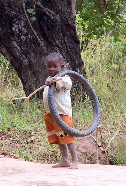 Mozambique -- the forked stick pushes the tire along the road