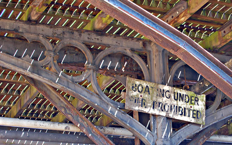 BOATING UNDER PIER PROHIBITED