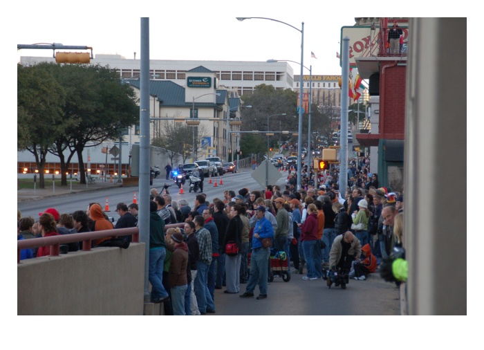 Crowd gathers on street...