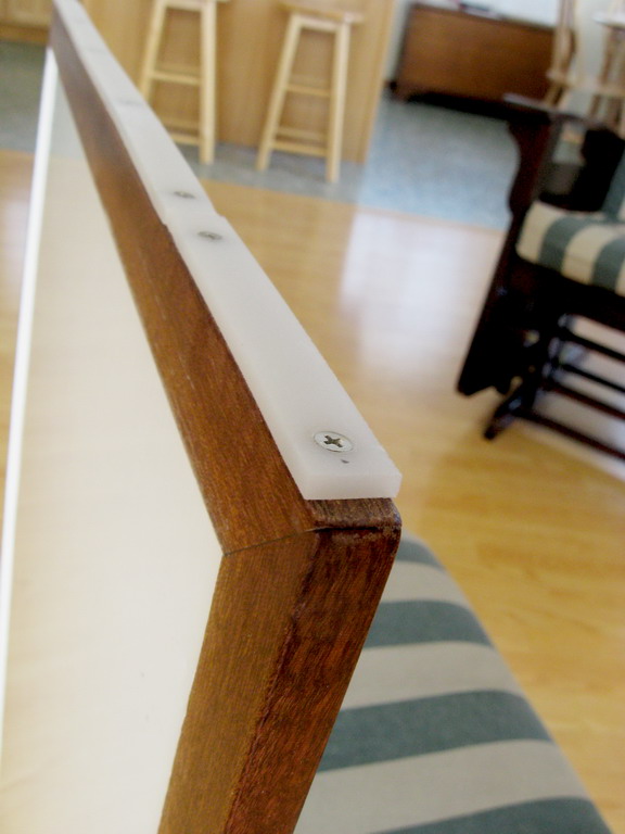 Layer of UHMW polyethylene screwed to the door bottom, for smoooth sliding.