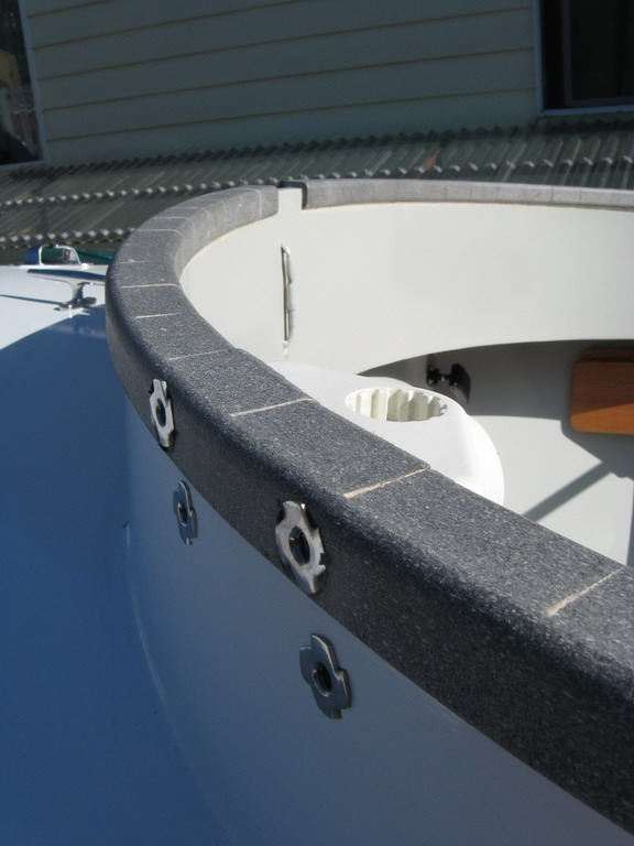 Quarter-20 tee nuts secure rod holder mount, starboard aft coaming.