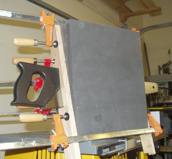 Cut on the diagonal to form two wedges.  Note guide boards.