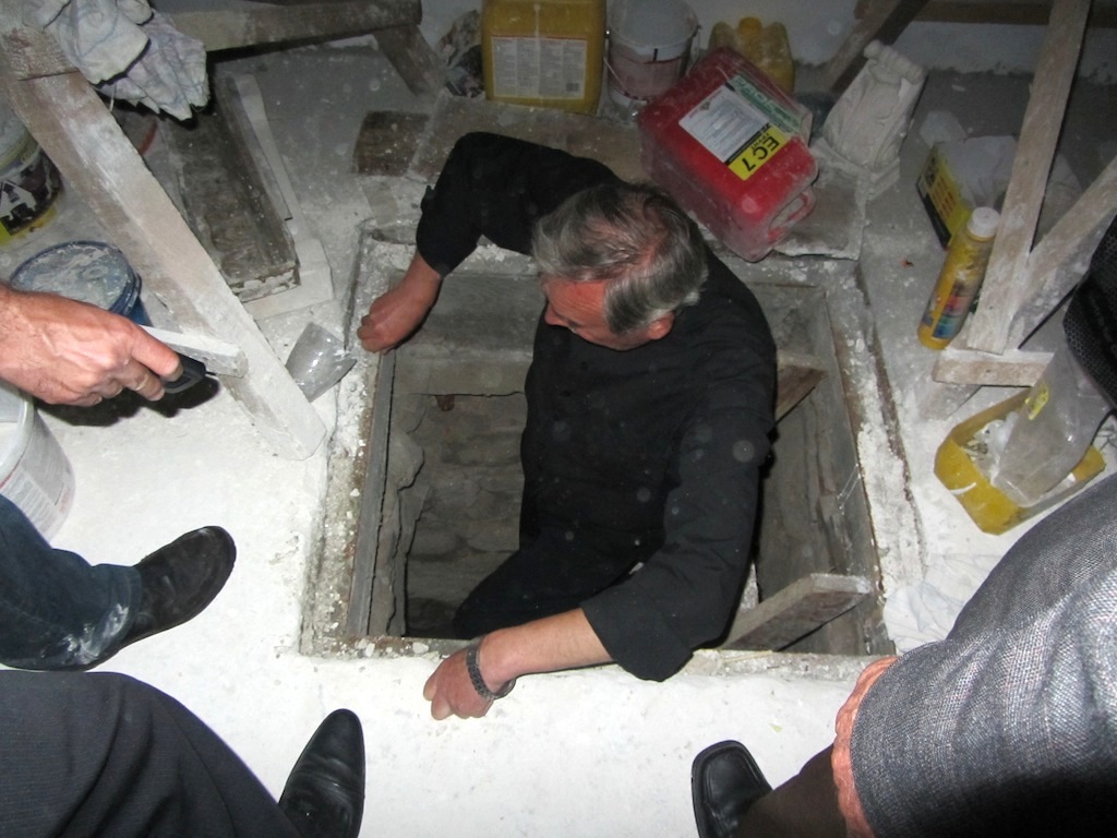 one of the priests takes us down into the cellar