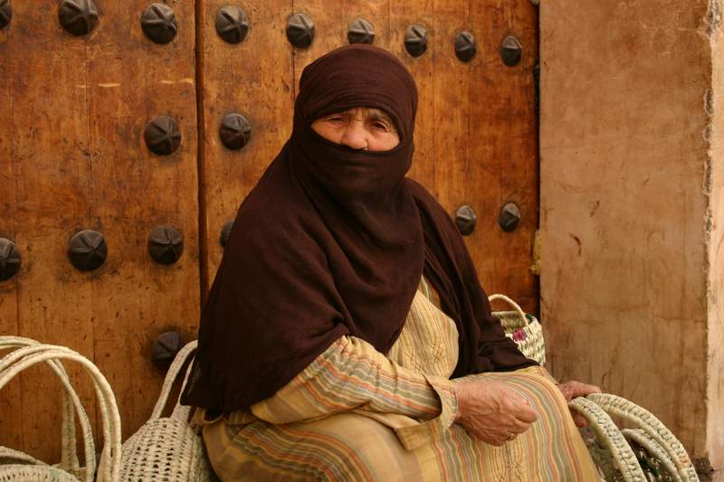 Berber Woman selling Baskets outside of the Medersa Ben Yousef