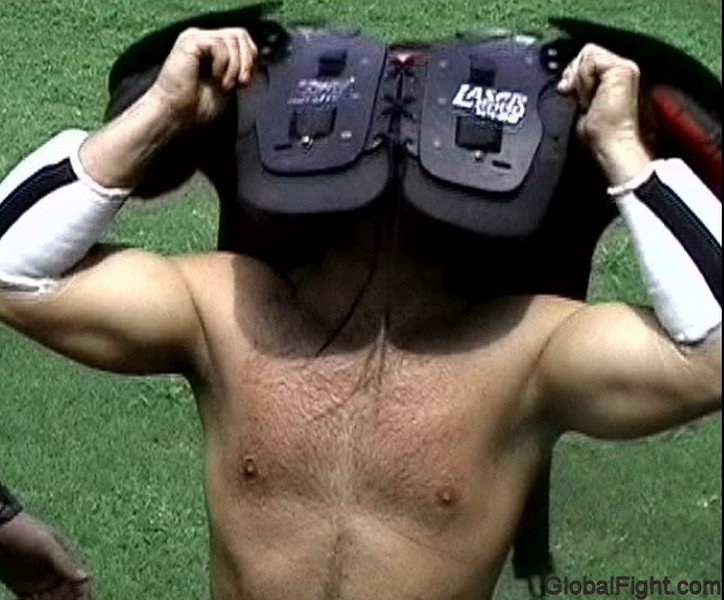 football players removing pads hairy chest.jpg