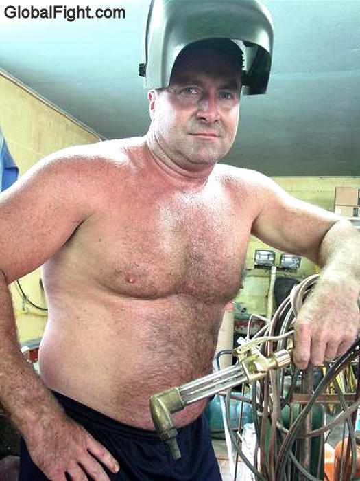 gay musclebear working welding shirtless garage.jpg