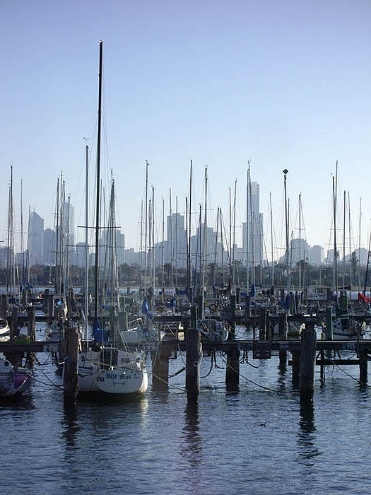 Early morning view of city beyond the masts of the St Kilda Marina