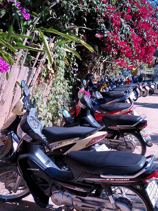 Motor scooters lined up at the end of the road
